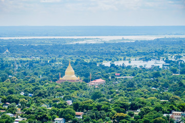 Fototapeta premium aerial view of Mandalay city with temples, gold pagoda, Irrawaddy river and bridges from sagaing hill. landmark and popular for tourists attractions in Myanmar