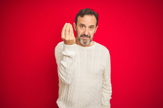 Handsome middle age senior man with grey hair over isolated red background Doing Italian gesture with hand and fingers confident expression