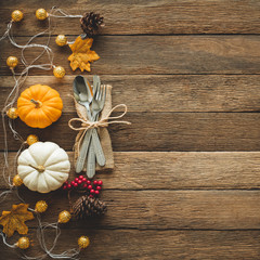 Thanksgiving background, pumpkin, leaves and decoration on wood table background with copy space. flatlay