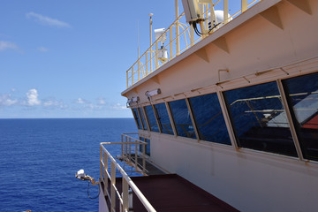 View of the navigation bridge of the cargo ship sailing through the ocean. 