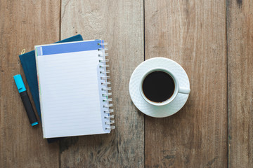 top view a cup of coffee with paper and note book