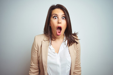 Young beautiful elegant business woman over isolated background afraid and shocked with surprise expression, fear and excited face.