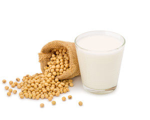 Glass of Soy milk with soybeans in bag isolated on white background.