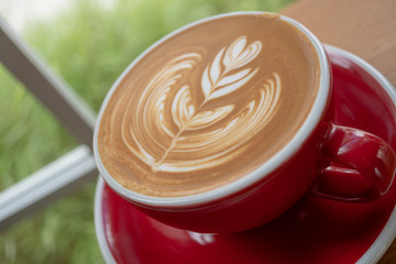 The latte art coffee served within ceramic cup