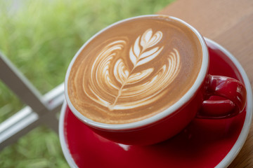 The latte art coffee served within ceramic cup