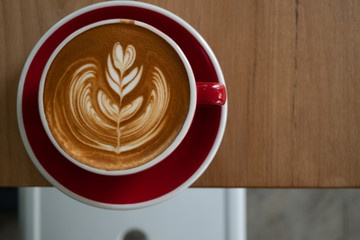 The latte art coffee served within ceramic cup