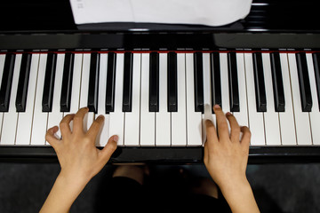 Two Small Childent's Hands Playing The Piano
