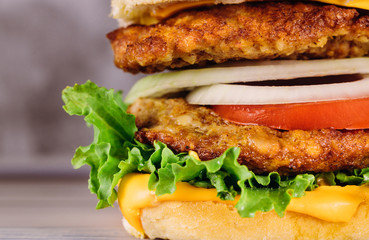 Classic cheeseburger with lettuce, onions, tomato and meat.