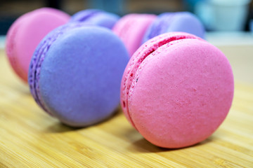 Cake macaron or macaroon on turquoise background from above, colorful almond cookies, pastel colors