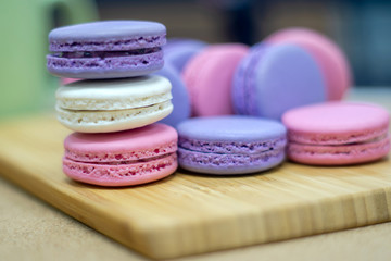 Cake macaron or macaroon on turquoise background from above, colorful almond cookies, pastel colors