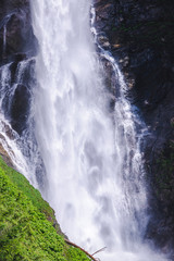 Fototapeta na wymiar Bottom of Waterfall Water Spray on Rocky Cliffs