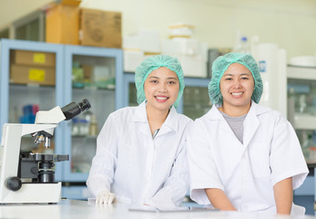 Two scientist a smile in laboratory, Concept of science and technology