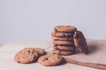 Chocolate chip cookies on brown background.