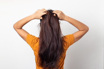 Women itching scalp itchy his hair and was massaging her hair on a white background,Haircare concept
