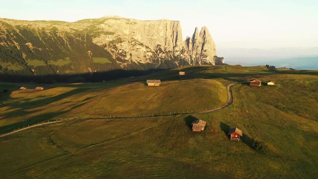 Aerial video of the sunrise in the Dolomites mountains. It was shot on the beautiful meadows of Seiser Alm plateau.