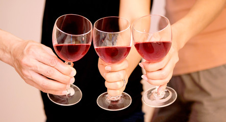 Hand of group friends celebrate successfully with red wine in the party. Young toasting in party and drinking after work hard for relax and be enjoy. Celebration Concept , Cheers!