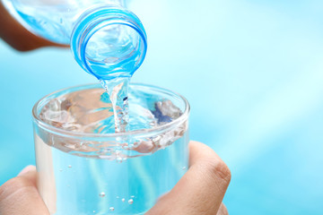Clean water for good health. Pouring Fresh Pure Water From Pitcher Into A Glass on table wooden. Health And Diet Concept. Lifestyle Healthcare And Beauty.