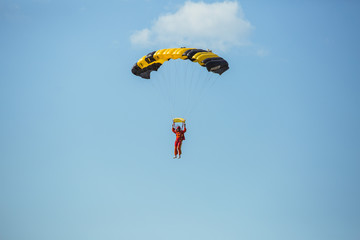 City Riga, Latvian republic. Avio show in honor of the city festival. Parachutists land with parachutes on target. 17 August 2019.