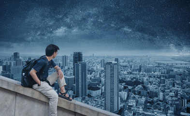 a man with backpack with futuristic city skyline