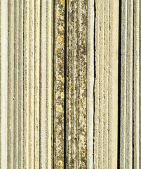 Corrugated slate lies in a pile, side view background texture of slate.