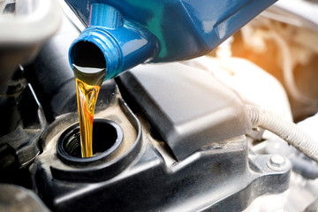 Refueling and pouring oil quality into the engine motor car Transmission and Maintenance Gear .Energy fuel concept.