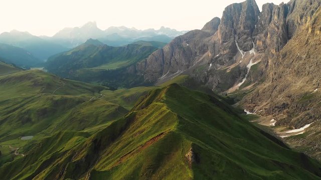 Aerial video of the sunrise in the Dolomites mountains. It was shot on the beautiful meadows of Seiser Alm plateau.