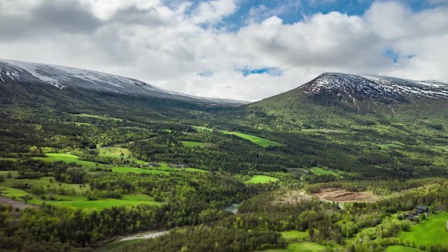 Aerial view of Trollheimen national park, Norway. Beautiful valley with a wild river, pristine forest, and mountains around it.