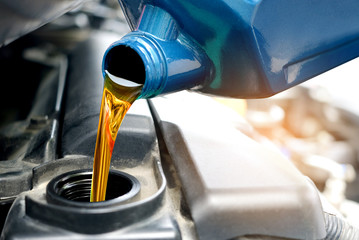 Refueling and pouring oil quality into the engine motor car Transmission and Maintenance Gear .Energy fuel concept.
