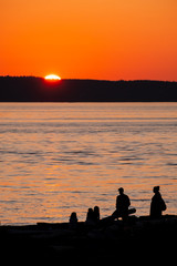 Fototapeta na wymiar Silhouettes of beach goers at sundown