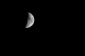 A half moon against a dark night sky