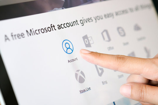 November 25, 2018 in Bangkok, Thailand. Beautiful woman's hand touches her computer screen. And are applying for a system account.