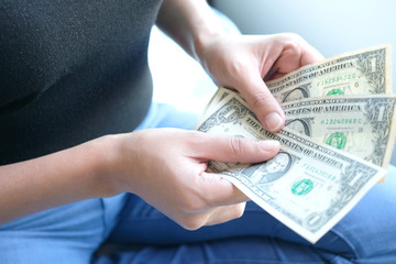 woman's hand works for the money, she offer banknotes with partner for investment business, she count the dollar for bill payment. Exchange money. Financial concepts , Business Concept.