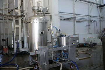 shiny tanks or barrels at a beer and wine factory. Industry Brewing and winemaking. Equipment for the winery and brewing industrial
