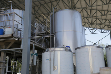shiny tanks or barrels at a beer and wine factory. Industry Brewing and winemaking. Equipment for the winery and brewing industrial interior of a factory