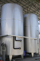 shiny tanks or barrels at a beer and wine factory. Industry Brewing and winemaking. Equipment for the winery and brewing industrial interior of a factory