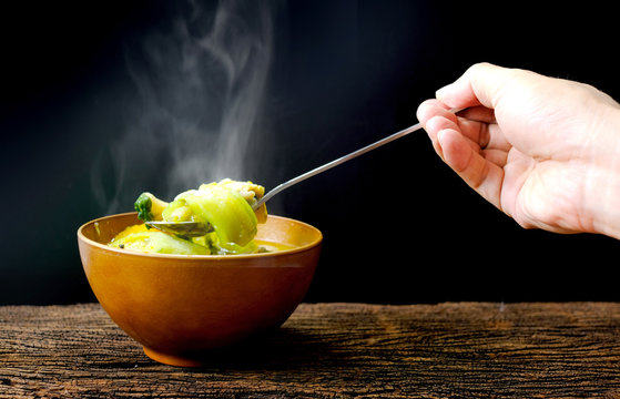 Decorate food, Japanese Food , Breakfast , Lunch and dining by hot soup in wood bowl on mat which have a smoke on bowl black background.