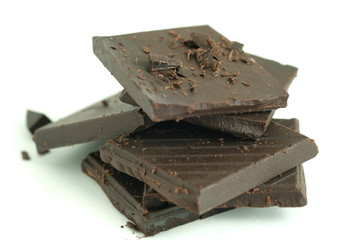 Chocolates are cut into pieces on a white background. Snack ideas