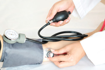 Doctor woman check blood pressure monitor and heart rate monitor pressure gauge. Health care and ...