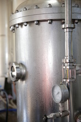 shiny tanks or barrels at a beer and wine factory. Industry Brewing and winemaking. Equipment for the winery and brewing