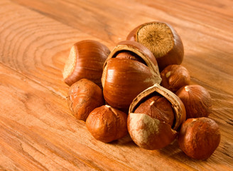 Isolated image of hazelnuts on a wooden surface closeup