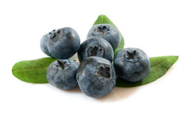 Group of blueberries with leaves on a white background closeup.