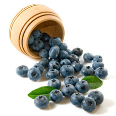 blueberries scattered from a barrel on a white background closeup.