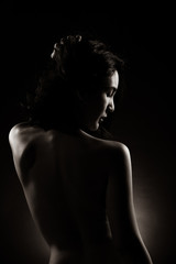 Naklejka premium Slim Sexy woman in Black White Monotone sensual post short black hair turn shape body, Beautiful Fashion Model posing naked and cover with arms legs, studio lighting dark background back rim light