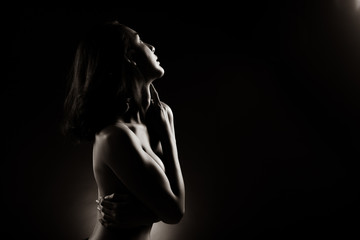 Slim Sexy woman in Black White Monotone sensual post short black hair turn shape body, Beautiful Fashion Model posing naked and cover with arms legs, studio lighting dark background back rim light