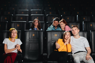 audience being afraid for the life of heroes while watching the adventure film, close up photo