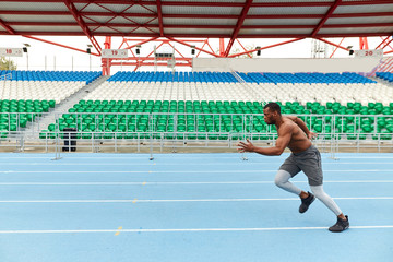 nude muscular man paticipating in the marathon. full length side view photo. copy space....