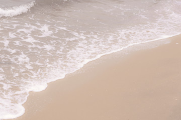 Soft wave at the sea on the sandy beach. Background
