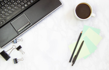 Business concept frame with laptop on a marble background. Workplace view from above. Copy space