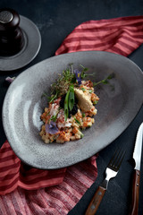Olivier with crab meat in a beautiful bowl in the form of oysters, on a dark background. Food photo in no way, the concept of food fashion. Healthy nutrition.