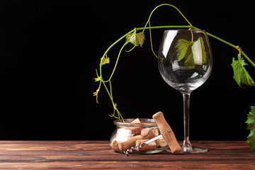 glass of  wine with corks on dark background .
